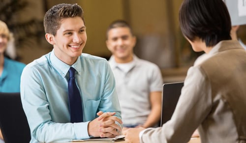 Confident student being interviewed by college job recruiter