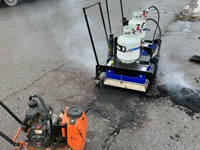 Using a RY2X2 infrared machine to last recycled asphalt repairs longer. 