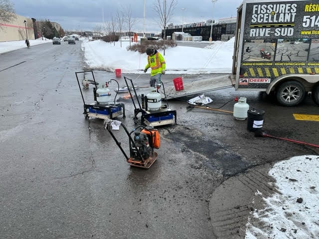A contrator repairing potholes using the RY2X2 infrared asphalt heater to prevent parking lot accidents in winter. 
